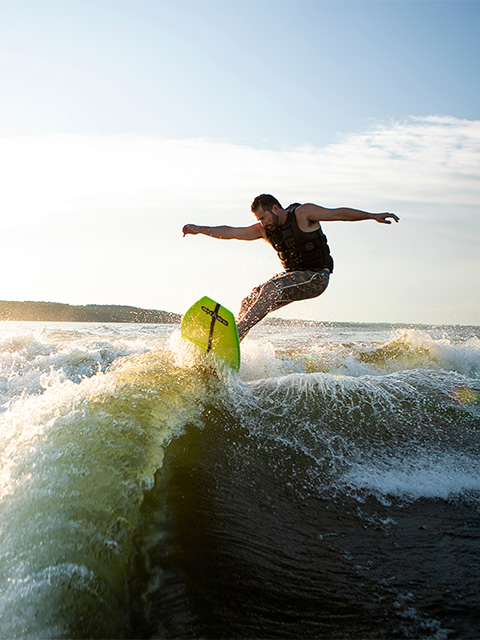 Guy wake boarding on lake